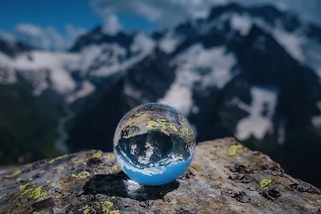 Original landscape photo of a crystal ball on a rock, 2,000 × 1,333