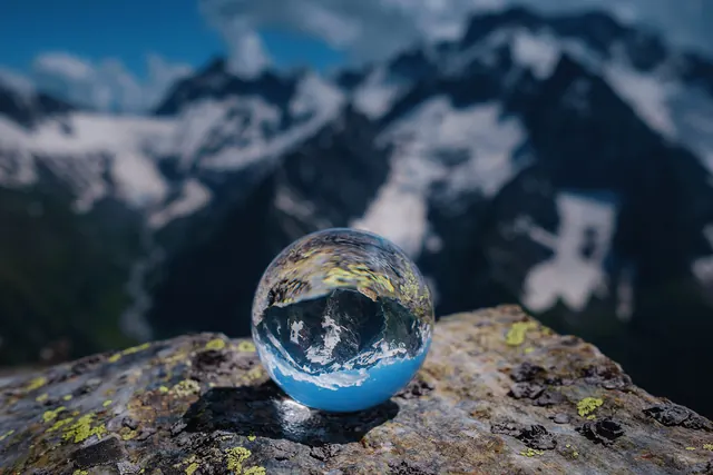 Photo of a crystal ball reflecting mountains as a HEIC file, 1.0 MB