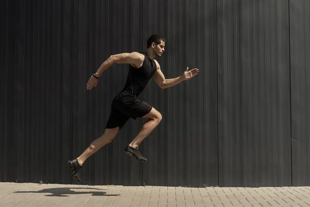 The same photo flipped horizontally, so the sprinter runs to the left