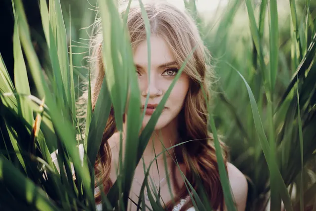 Original landscape portrait of a woman framed by tall grass, 3,000 × 2,000